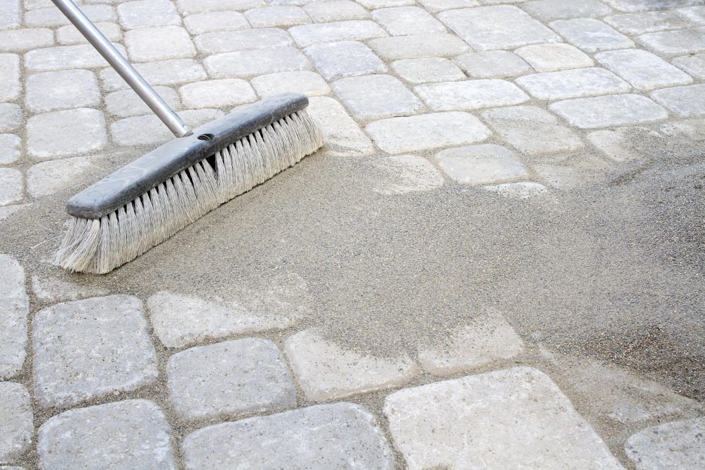 brushing the sand on the pavement