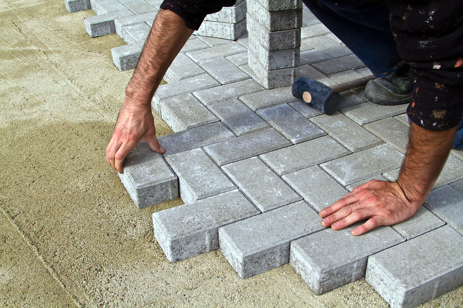 worker installing stone bricks